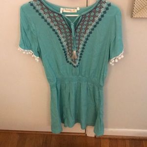 A light blue dress with embroidery on the top